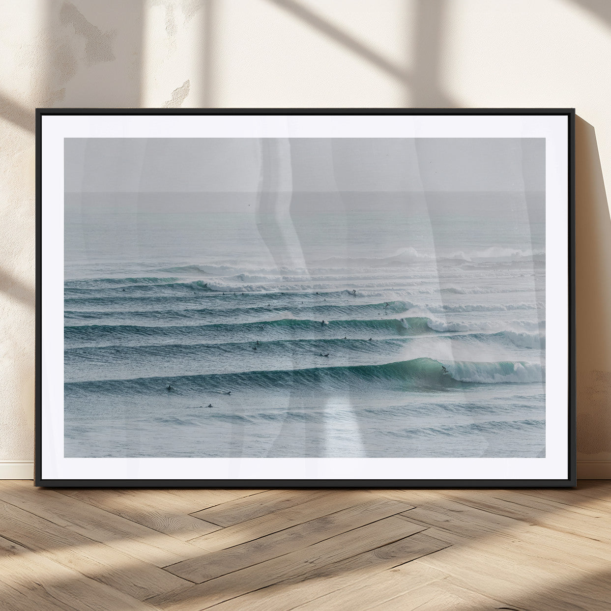 High-angle view of surfers lining up across layered ocean waves, ideal for minimal coastal or surf-inspired room decor.