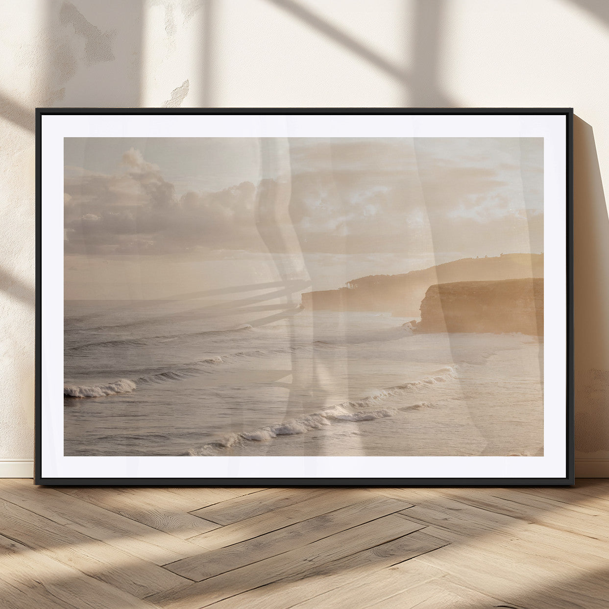 Golden hour seascape with misty cliffs and gentle waves rolling towards the shore, capturing a tranquil and warm coastal atmosphere.