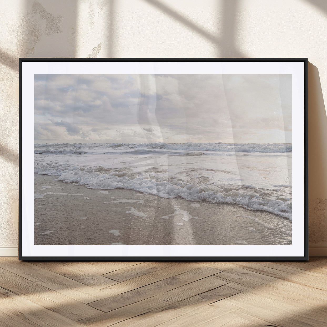 Peaceful ocean waves rolling onto the sandy shore under soft light, perfect for neutral or coastal minimalist decor themes.