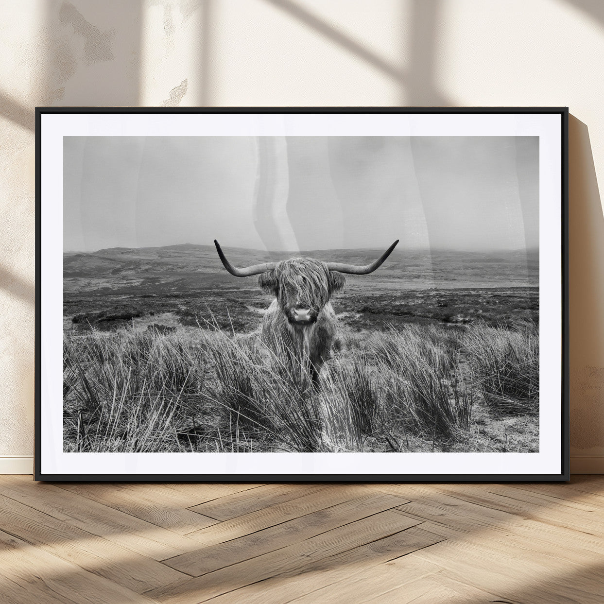 A black and white portrait of a Highland cow in a foggy Scottish countryside, capturing a rustic aesthetic and tranquil farm escape.