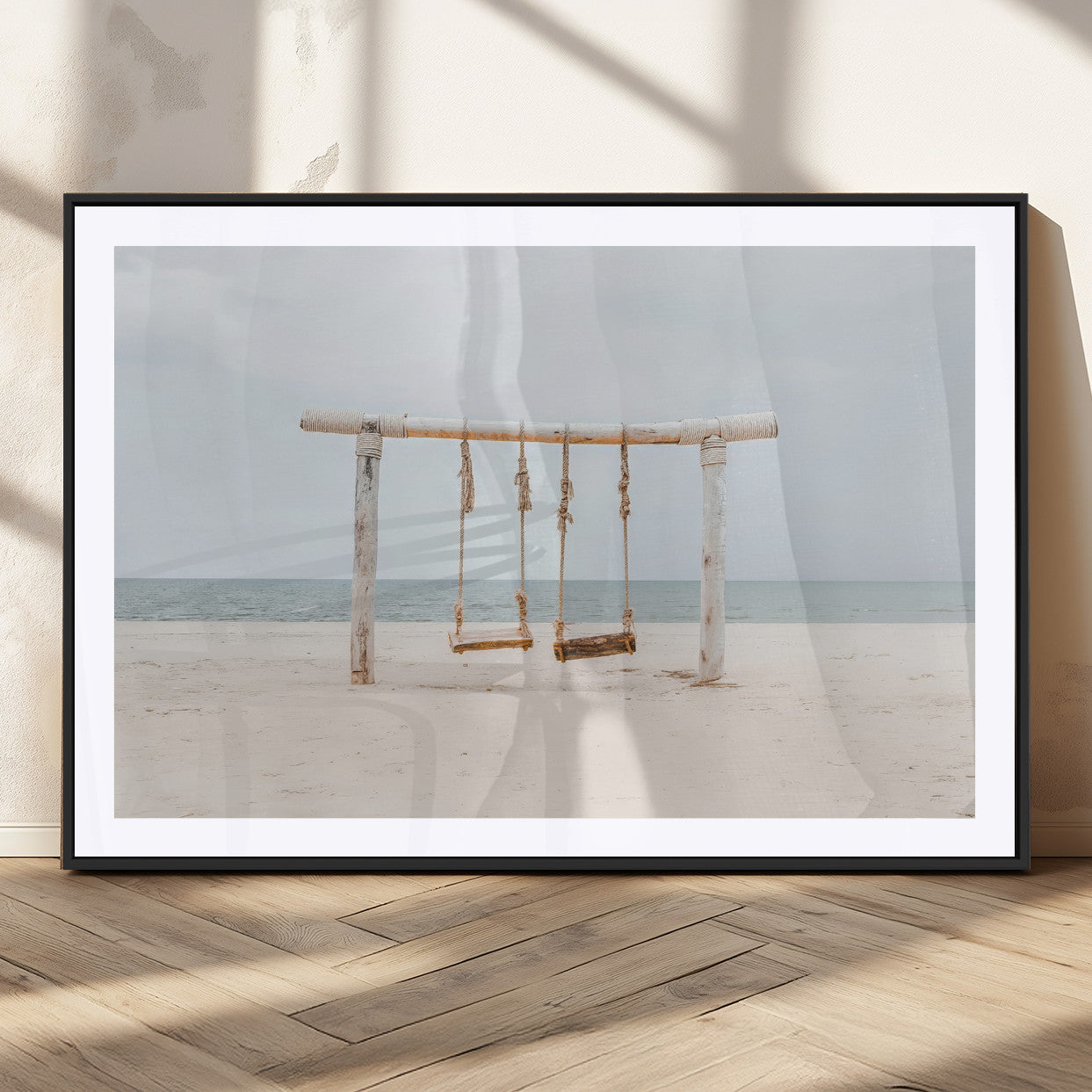 A rustic wooden beach swing stands on a serene sandy shore with an ocean horizon in the background, creating a tranquil and dreamy coastal escape.