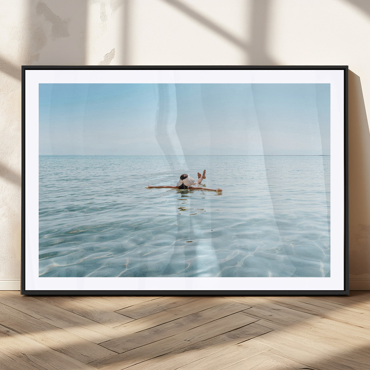 A peaceful minimalist scene of a person floating on crystal-clear water, surrounded by a vast open horizon, capturing relaxation and serenity in a tranquil aquatic setting.