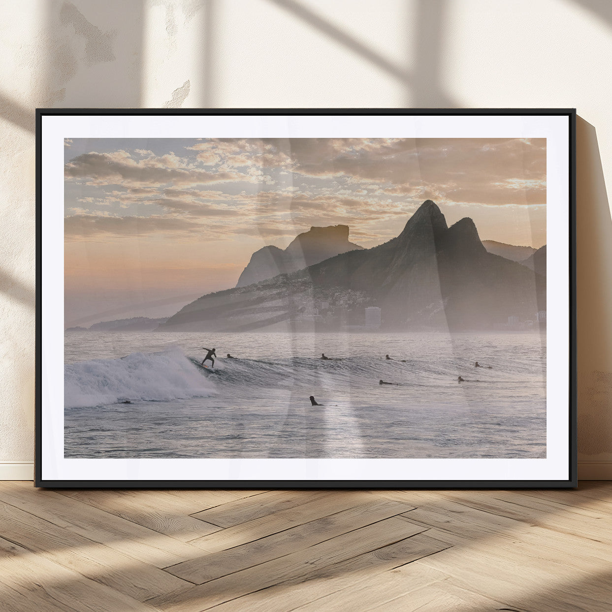 A surfer rides a golden hour wave near misty coastal mountains, surrounded by fellow surfers, capturing the spirit of a coastal adventure.