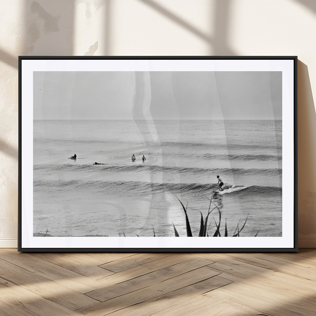 Monochrome canvas of surfers on calm ocean waves, ideal for minimalist coastal or beach-inspired interior decor.