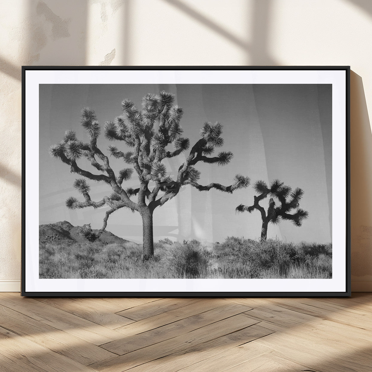 Black and white desert scene with two Joshua trees under clear sky, perfect for rustic or boho-inspired home decor.