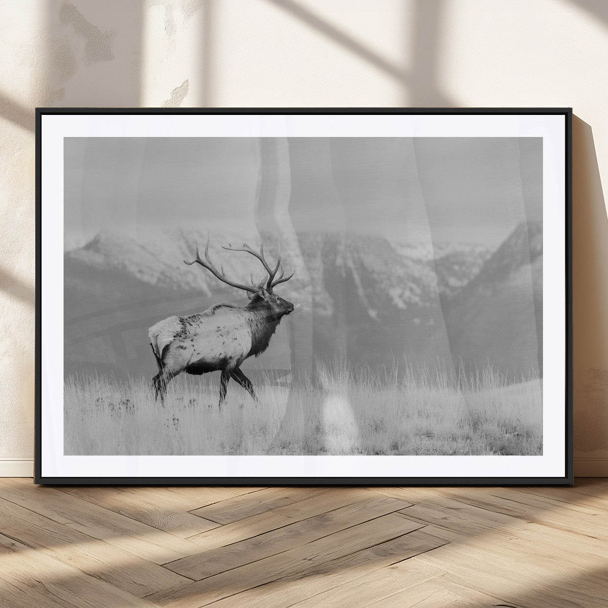 Black and white elk standing in front of snowy mountain range, perfect for rustic lodge or nature-inspired wall decor.