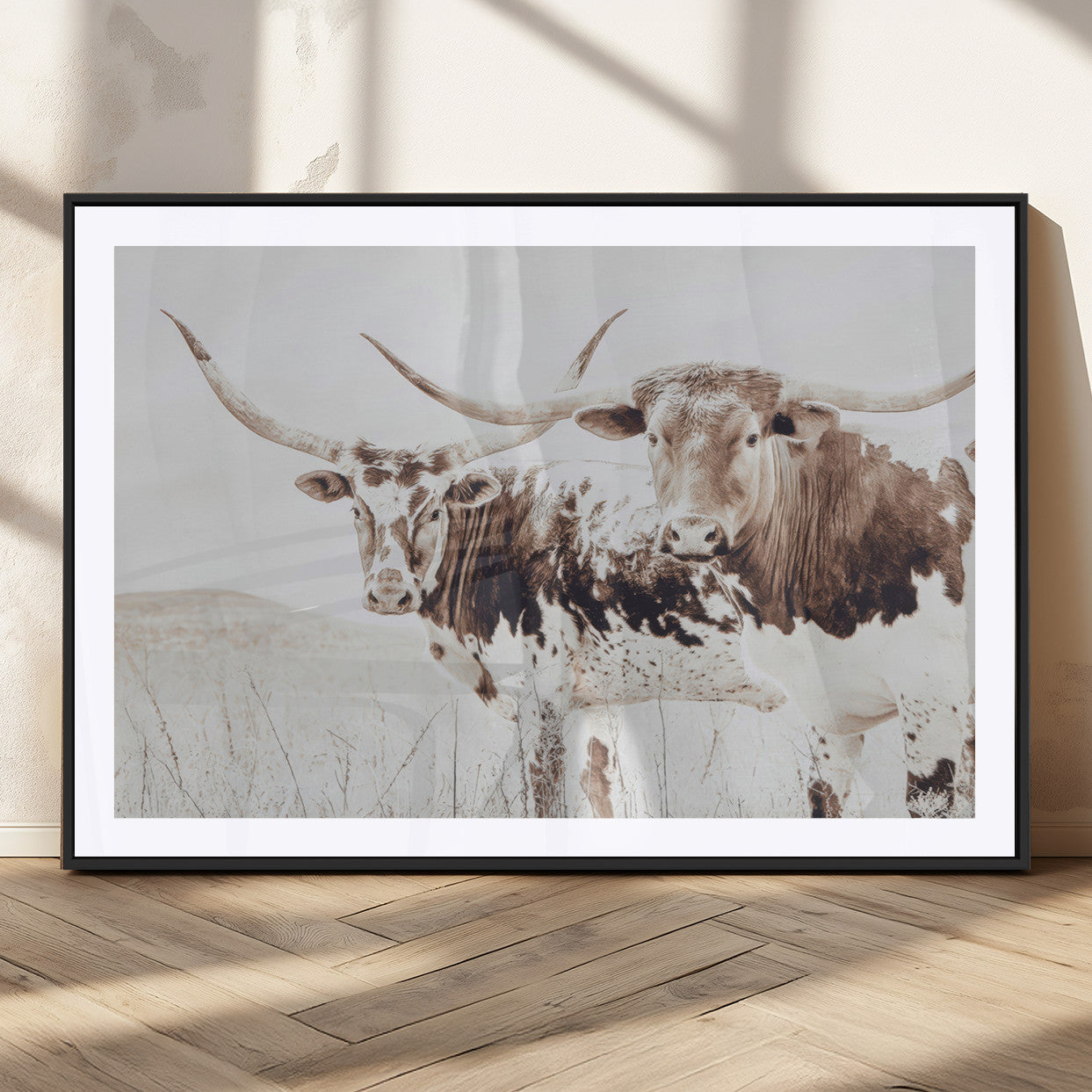 Two longhorn cows standing in a sepia-toned pasture with soft light, ideal for rustic or farmhouse-themed neutral wall decor.