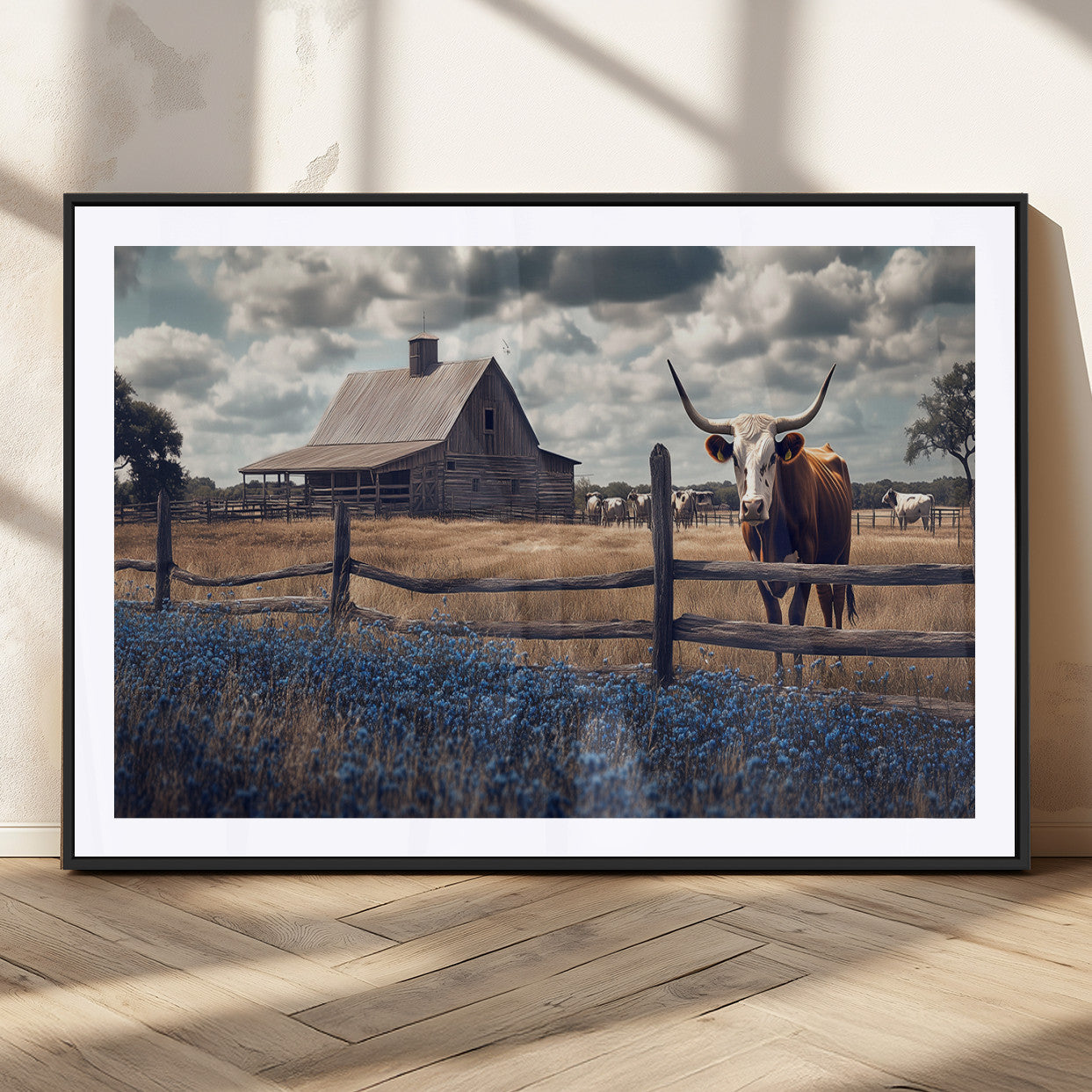 Framed canvas art of a Texas Longhorn cow near a rustic barn and bluebonnet field, ideal for country-style or farmhouse wall decor.
