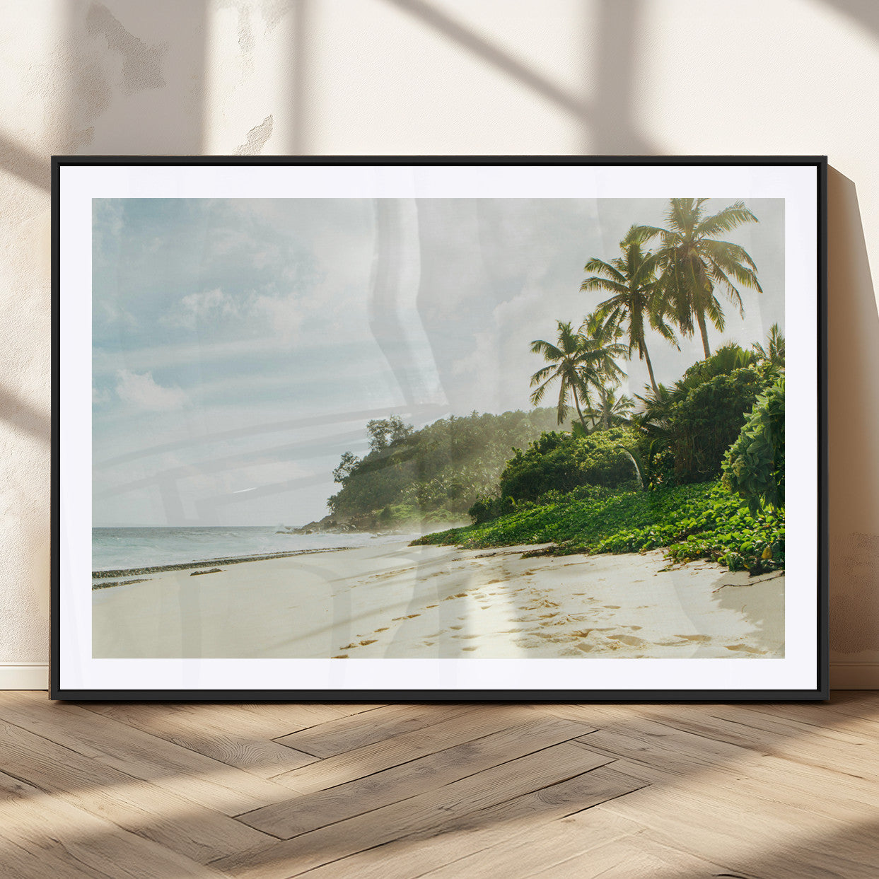 A tropical beach with palm trees, soft sand, and ocean waves under a bright sky, creating a peaceful and relaxing coastal view.