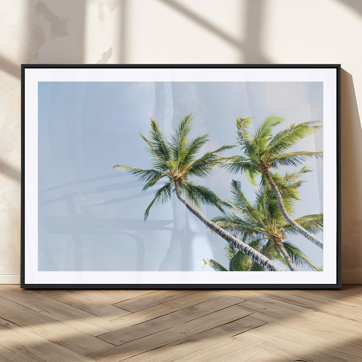Tall palm trees swaying under a bright blue sky, capturing a tropical and minimalist beach vibe, perfect for coastal-inspired wall art.