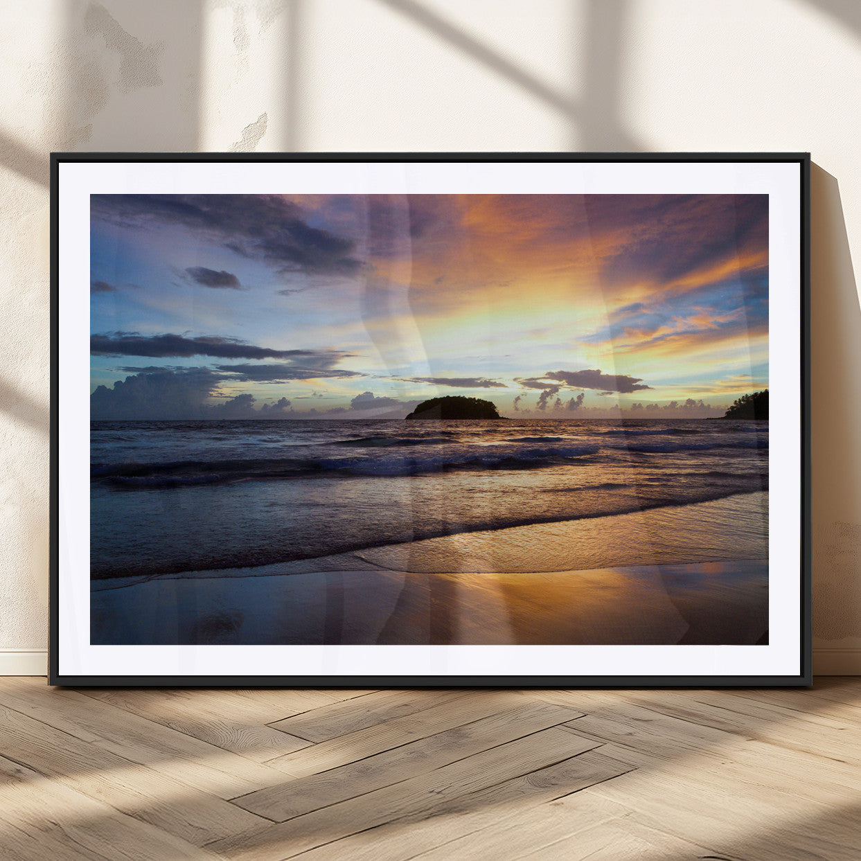 A tropical beach at sunset with waves gently washing ashore, reflecting golden and purple hues in the sky, creating a tranquil coastal scene.