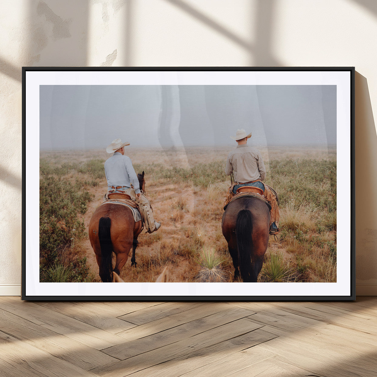 Two cowboys riding horseback through a misty prairie, capturing the rustic and adventurous spirit of the Western frontier.