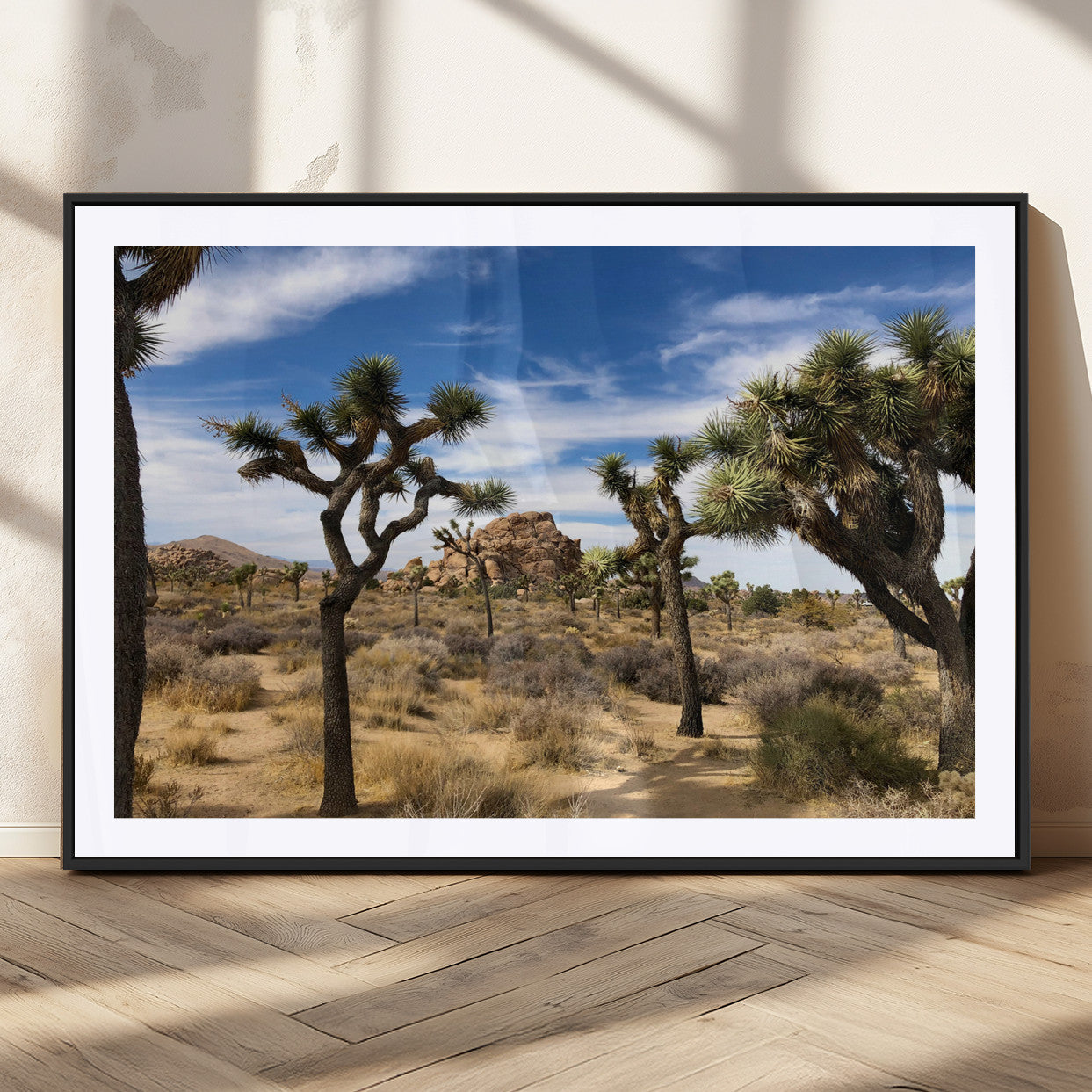 Scenic Joshua Tree landscape with rugged desert terrain, golden dry grass, and a deep blue sky, creating a warm, rustic Southwestern aesthetic.