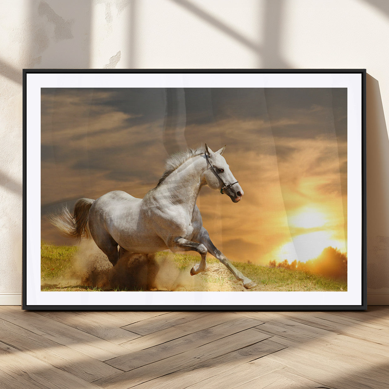 A powerful white horse galloping through the field at sunset, with the golden light illuminating its mane and the vibrant sky in the background.
