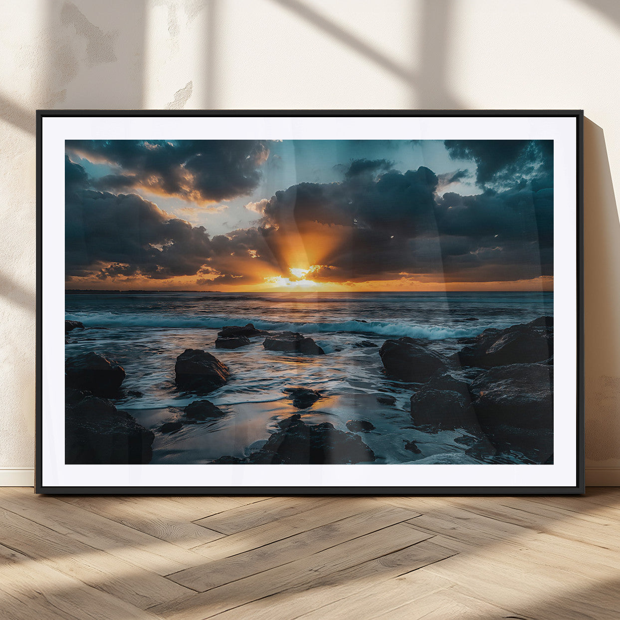 An awe-inspiring sunset over the ocean with rays of light piercing through dramatic clouds, creating a beautiful seascape with rocks in the foreground.