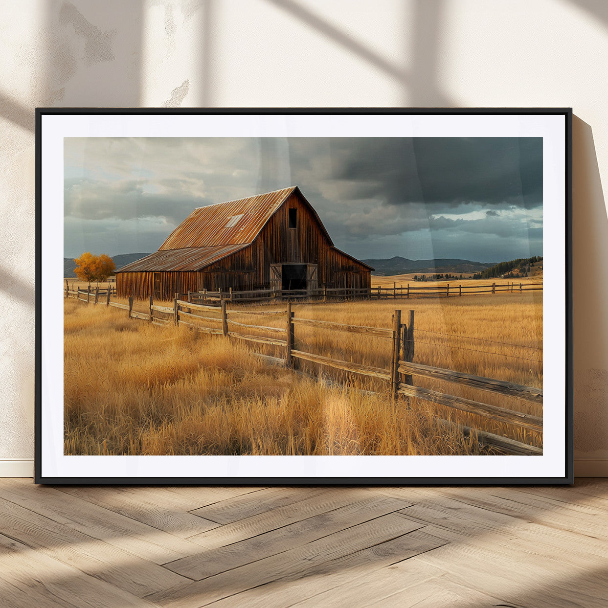 "Golden fields surrounding a rustic barn with a weathered roof, a wooden fence, and dramatic skies with sunlight breaking through the clouds."