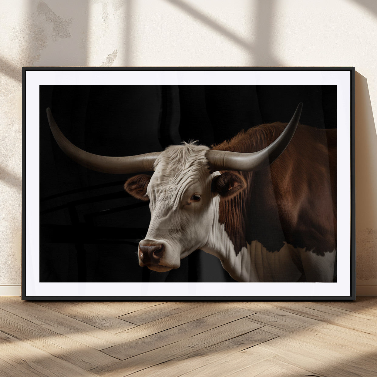 "Close-up of a brown and white longhorn cow with prominent curved horns against a black background."