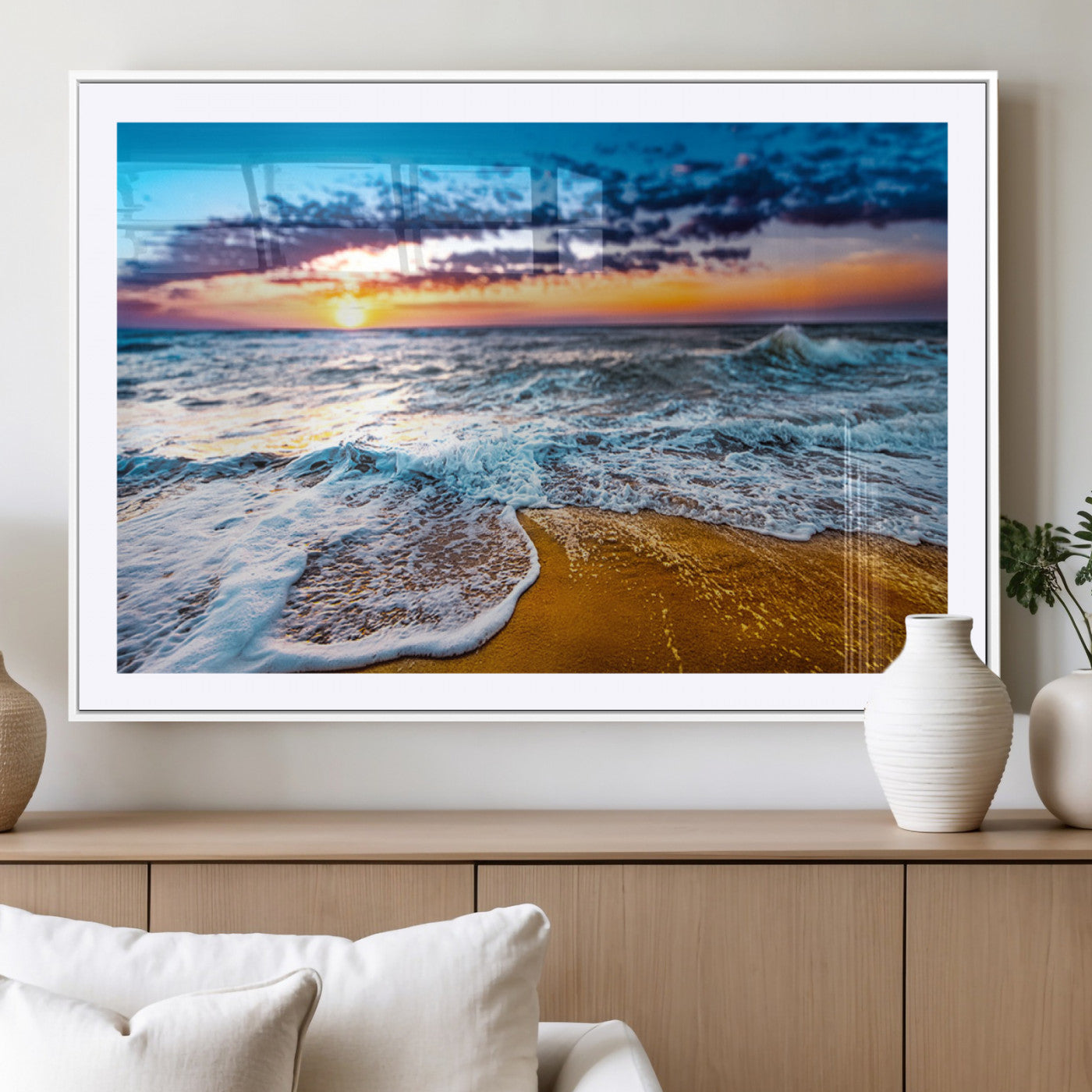 Beautiful ocean shoreline at sunset with foamy waves washing onto golden sand under a colorful sky – Wall Art Canvas Print.