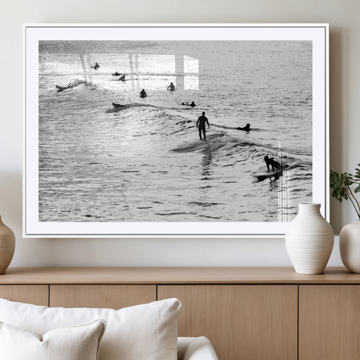19970637-MGC-FP-40x30_White-Black and white artistic view of surfers riding and paddling on waves in the ocean, capturing the dynamic motion and energy of surfing