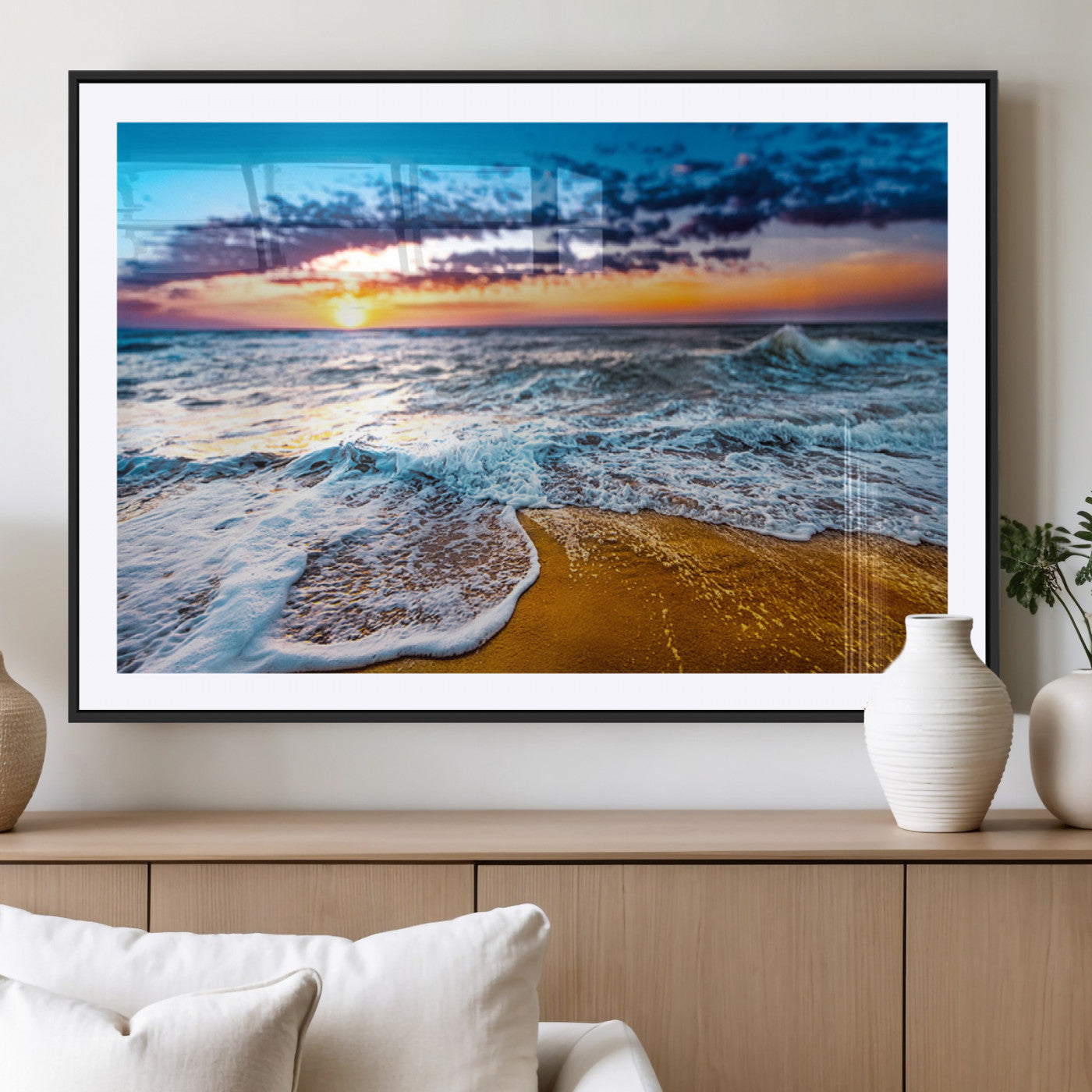 Beautiful ocean shoreline at sunset with foamy waves washing onto golden sand under a colorful sky – Wall Art Canvas Print.