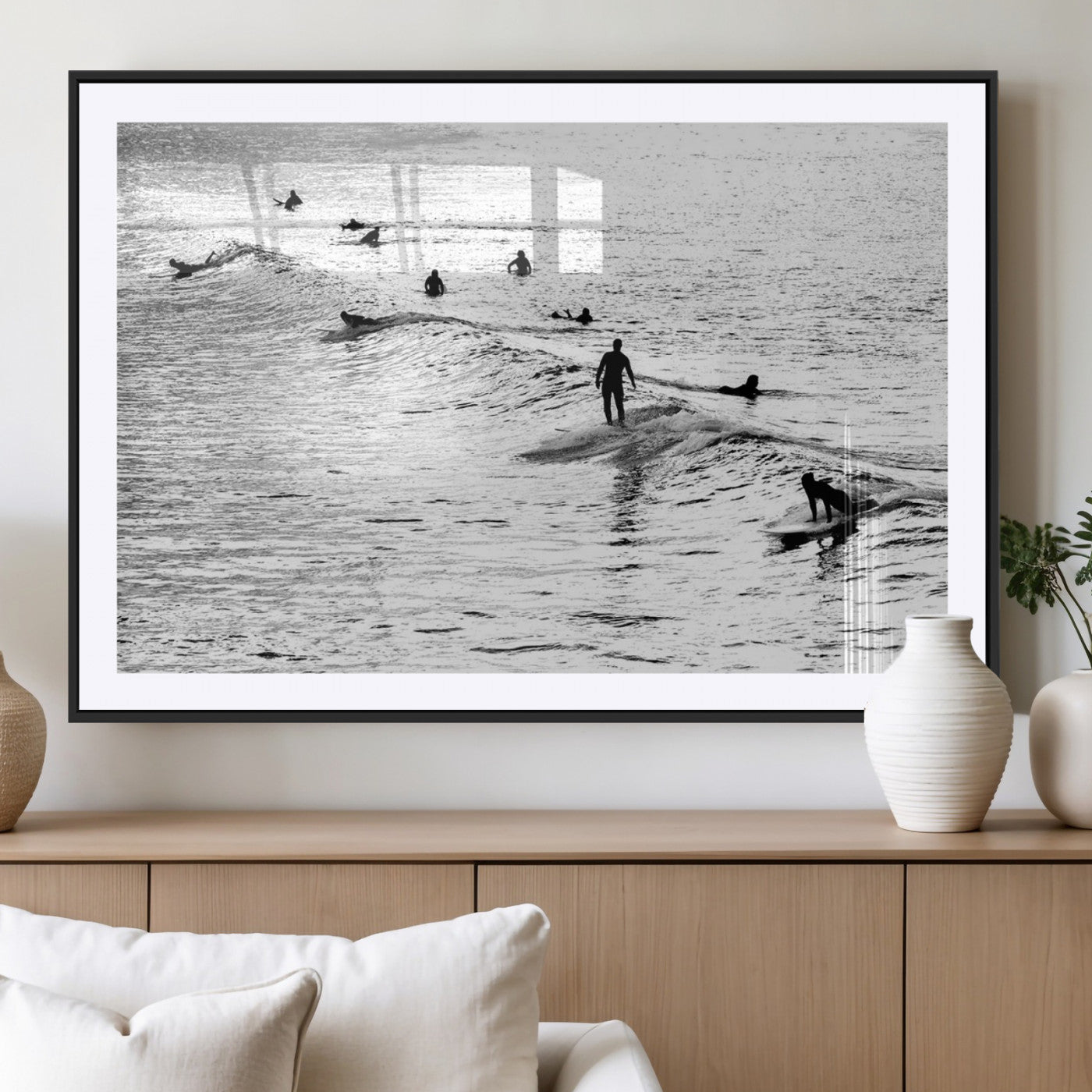 19970637-MGC-FP-40x30_Black-Black and white artistic view of surfers riding and paddling on waves in the ocean, capturing the dynamic motion and energy of surfing