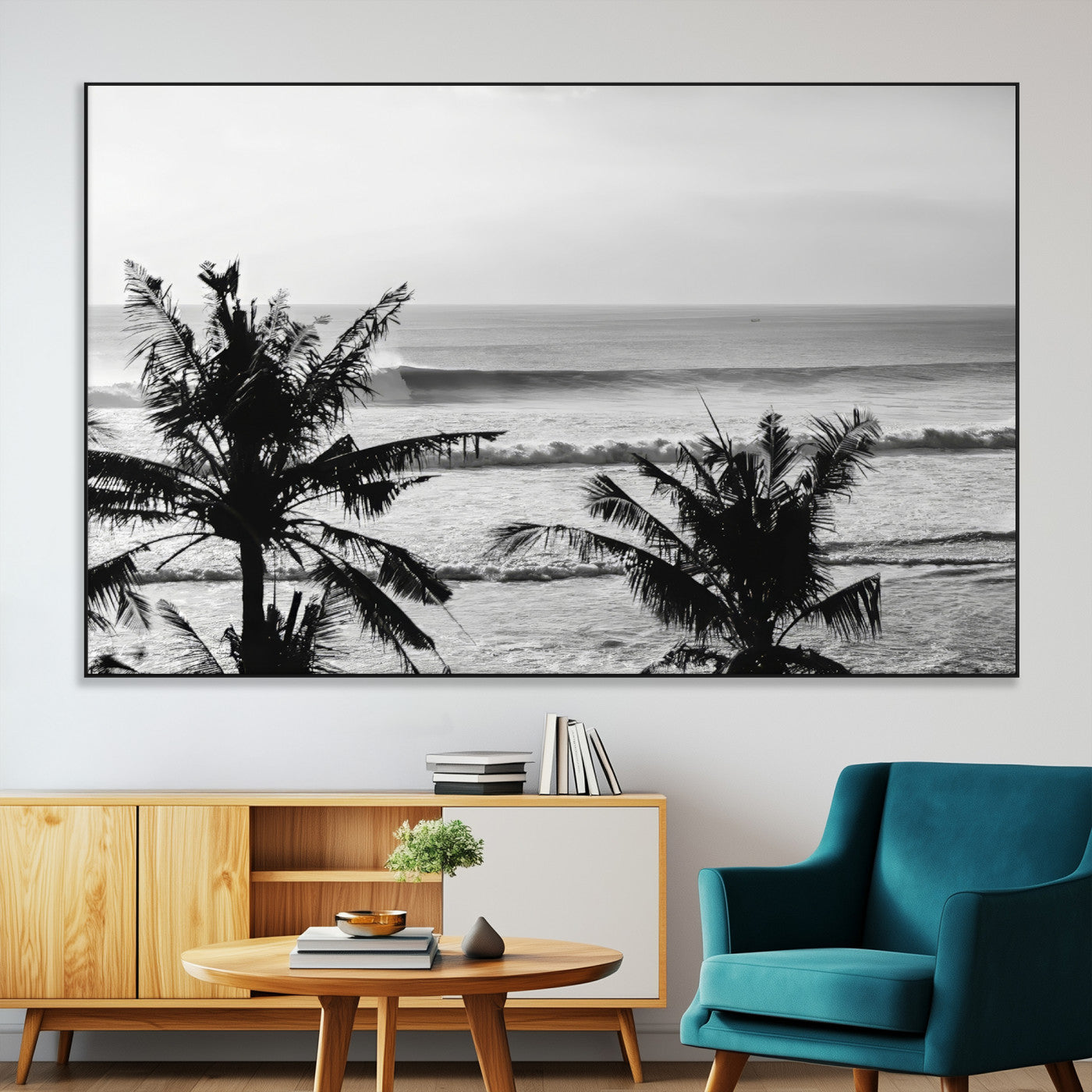 Black and white view of ocean waves crashing on a tropical coastline, framed by silhouetted palm trees under a vast, open sky.