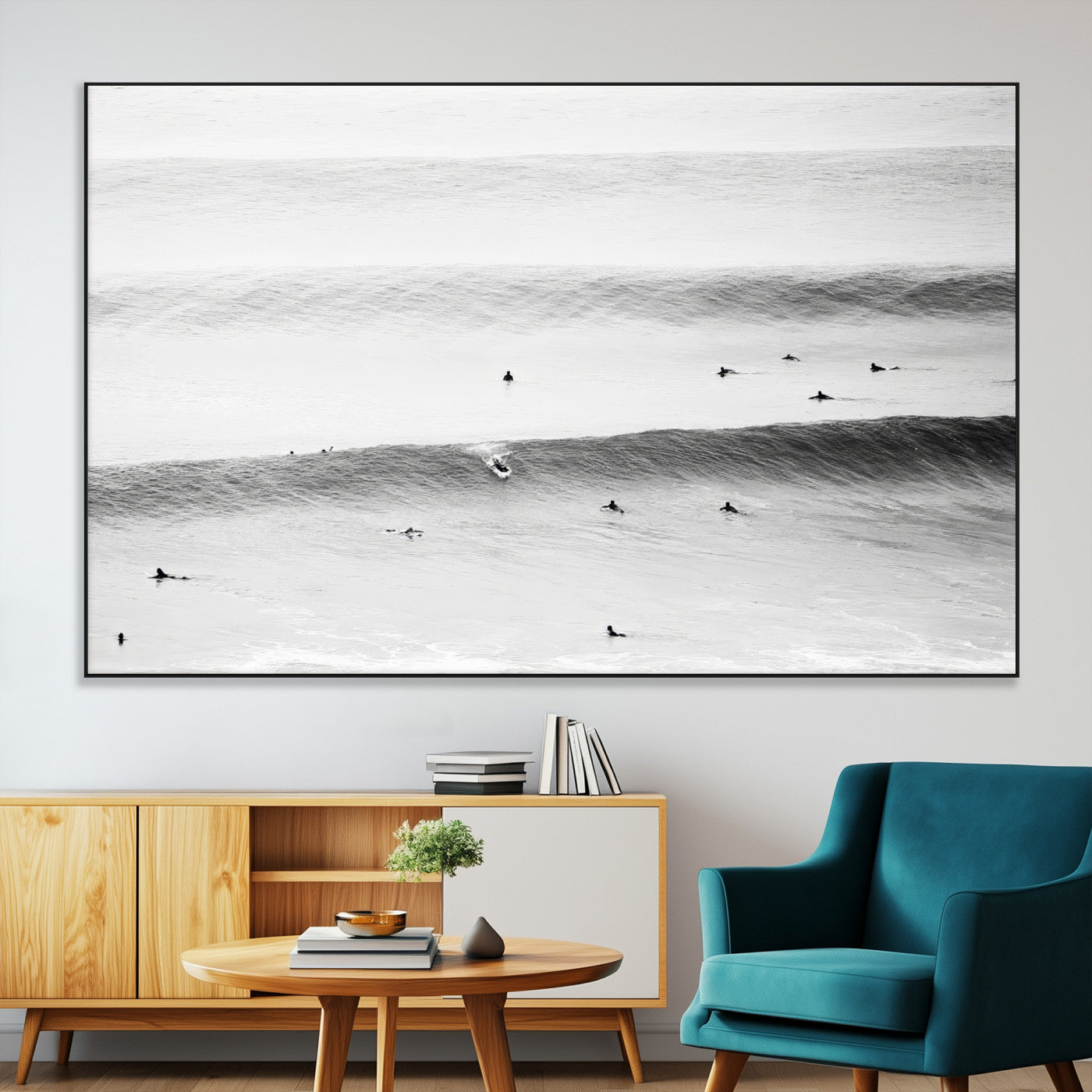 A monochrome photograph of swimmers gliding through gentle ocean waves, evoking a sense of calm and movement.