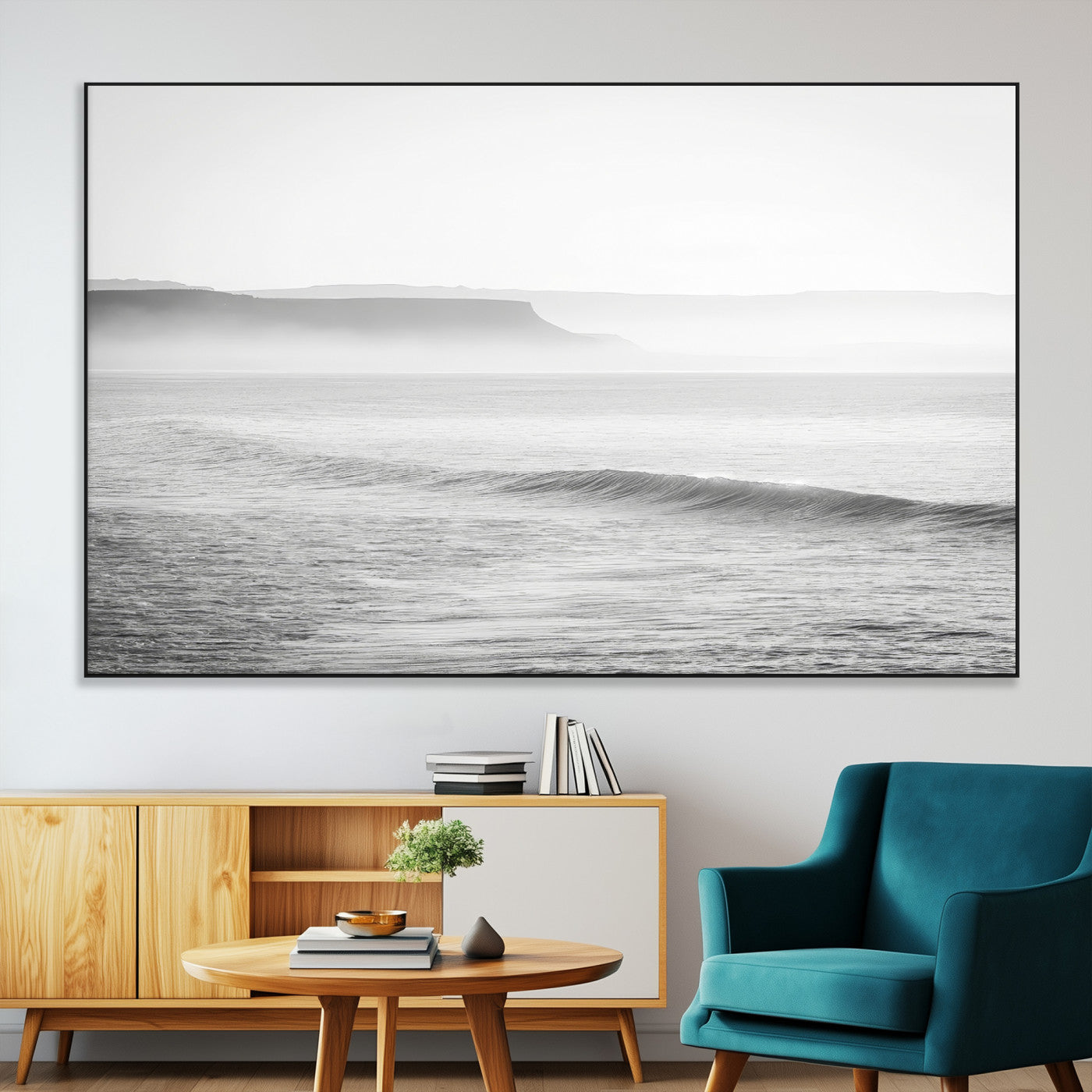 A black and white minimalist seascape featuring soft rolling waves and misty distant cliffs, creating a serene and timeless coastal atmosphere.