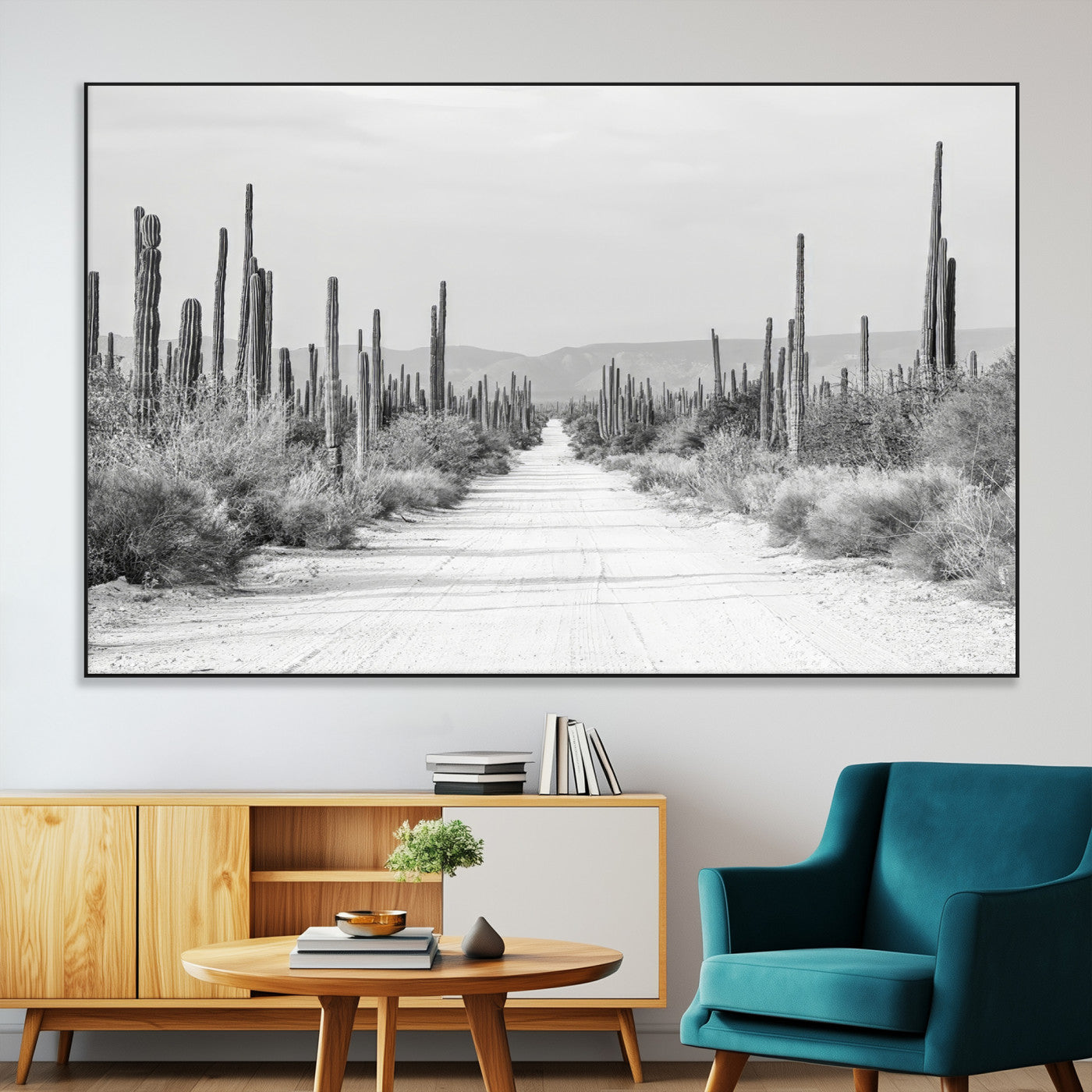 A black and white desert road stretching through a cactus-filled landscape, creating a rugged and timeless southwestern aesthetic with a sense of adventure.