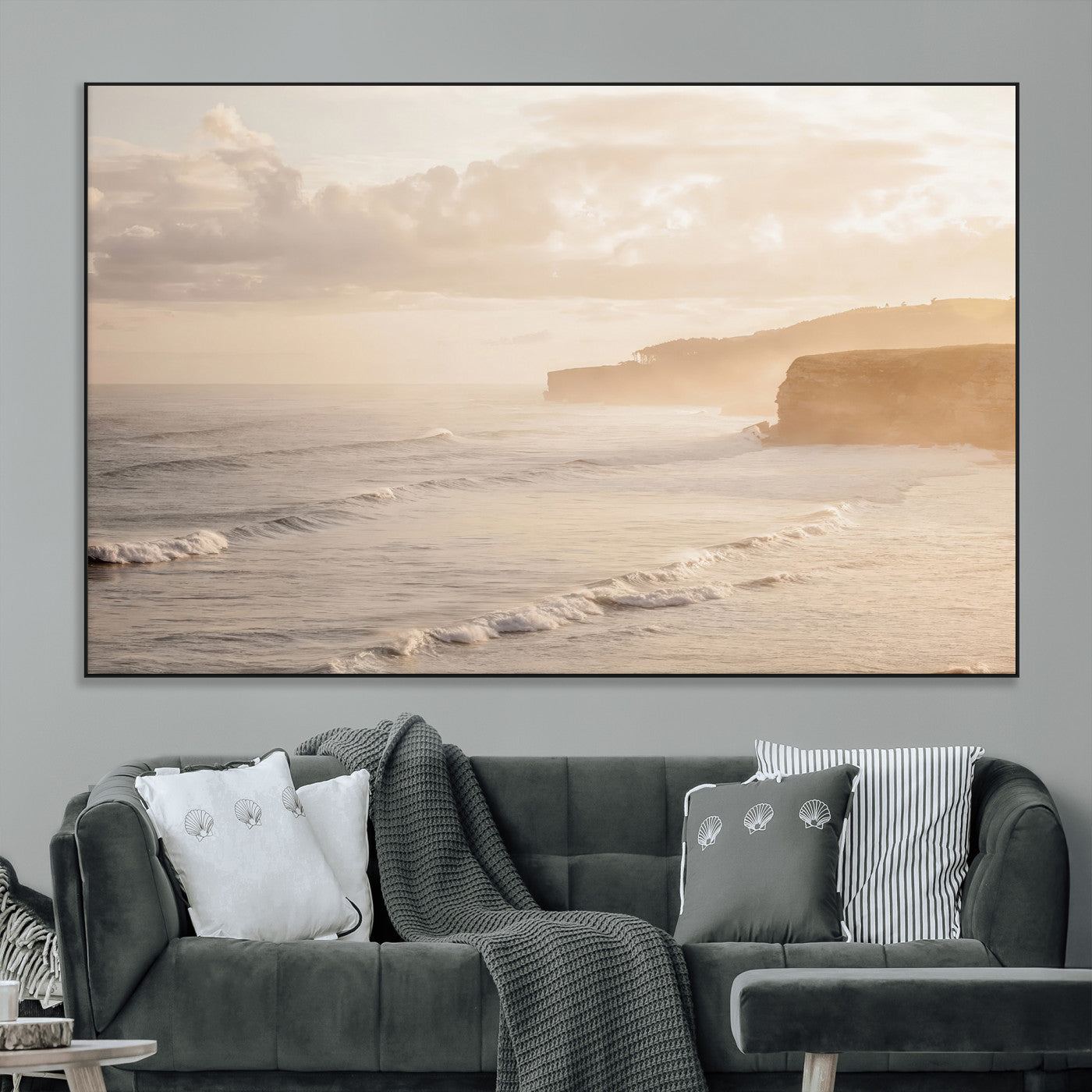 Golden hour seascape with misty cliffs and gentle waves rolling towards the shore, capturing a tranquil and warm coastal atmosphere.