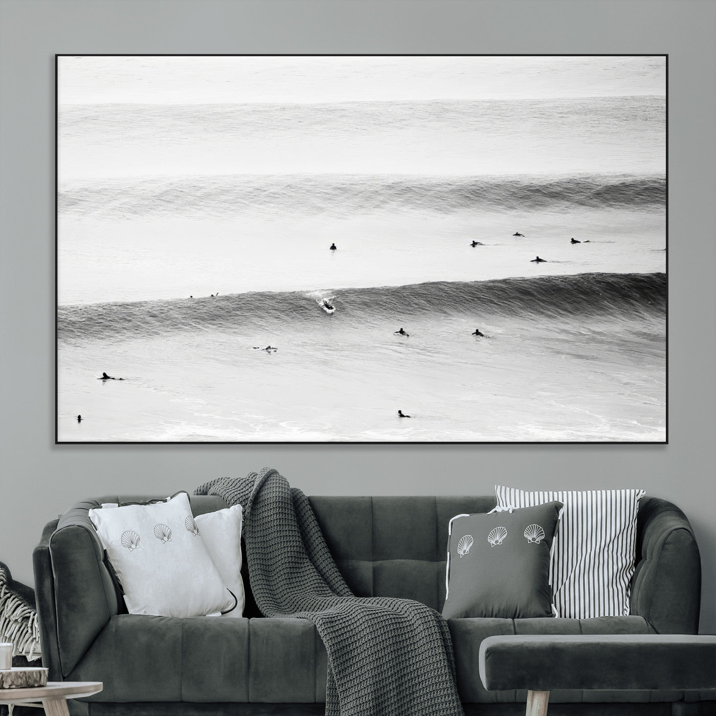 A monochrome photograph of swimmers gliding through gentle ocean waves, evoking a sense of calm and movement.