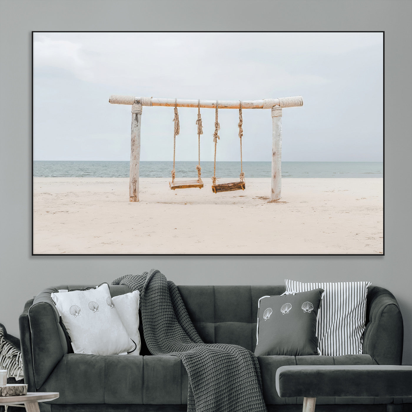 A rustic wooden beach swing stands on a serene sandy shore with an ocean horizon in the background, creating a tranquil and dreamy coastal escape.
