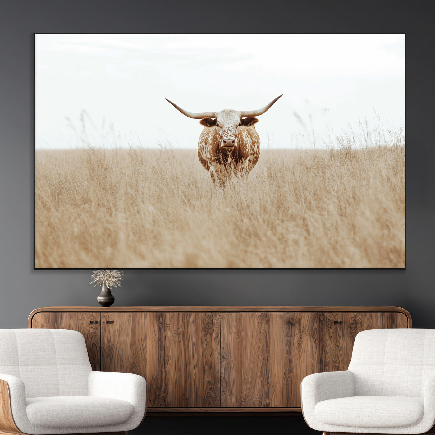 Texas Longhorn bull standing alone in dry grass with neutral tones, ideal for rustic western or cowboy-themed wall decor.