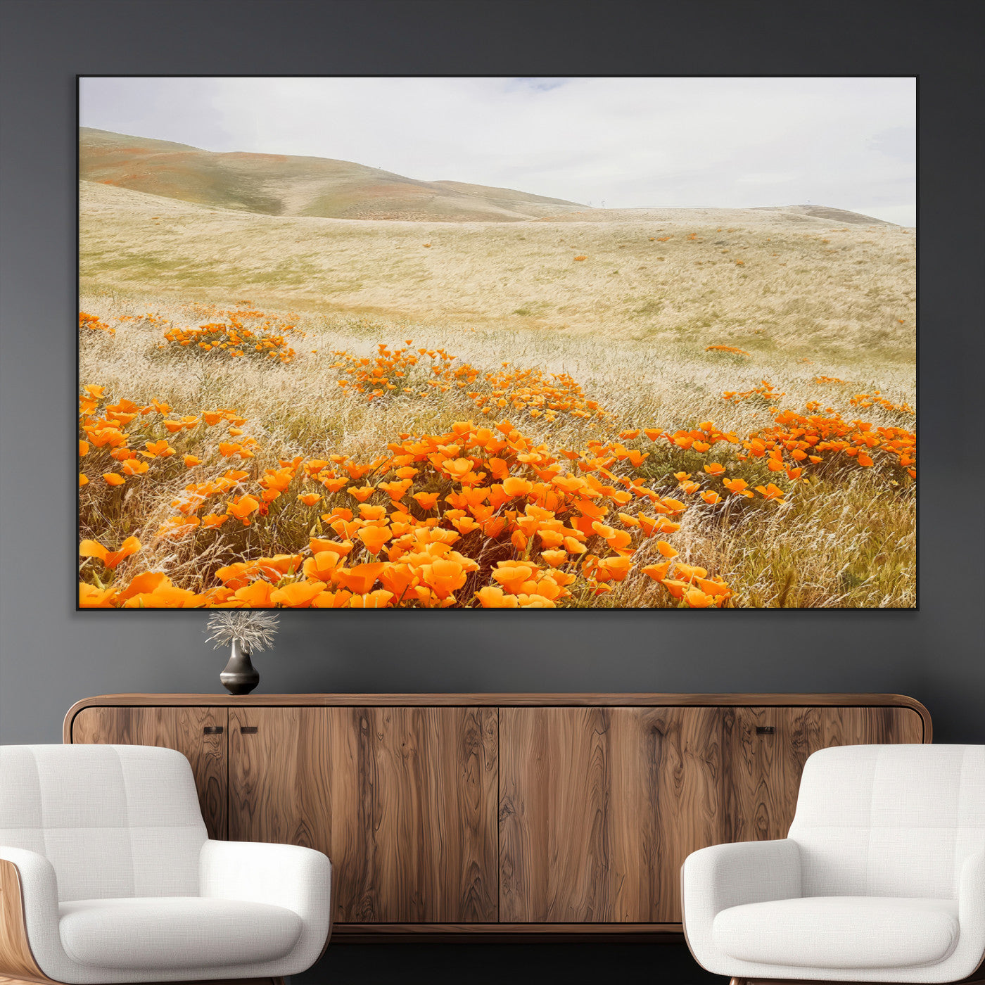 A golden field with vibrant orange poppies blooming across rolling hills under a soft, sunlit sky, creating a warm and rustic landscape.