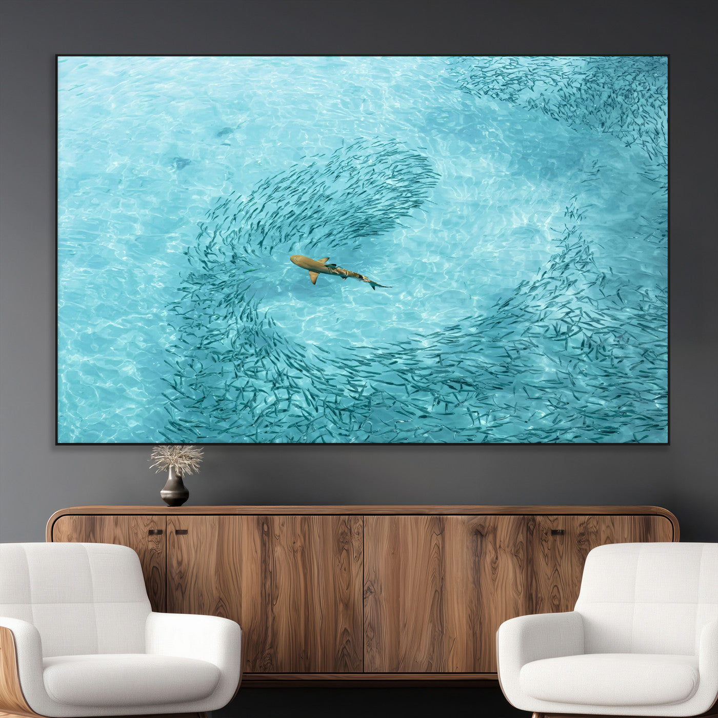 Aerial view of a shark swimming through a swirl of fish in clear turquoise waters, perfect for calm coastal or beach house decor.