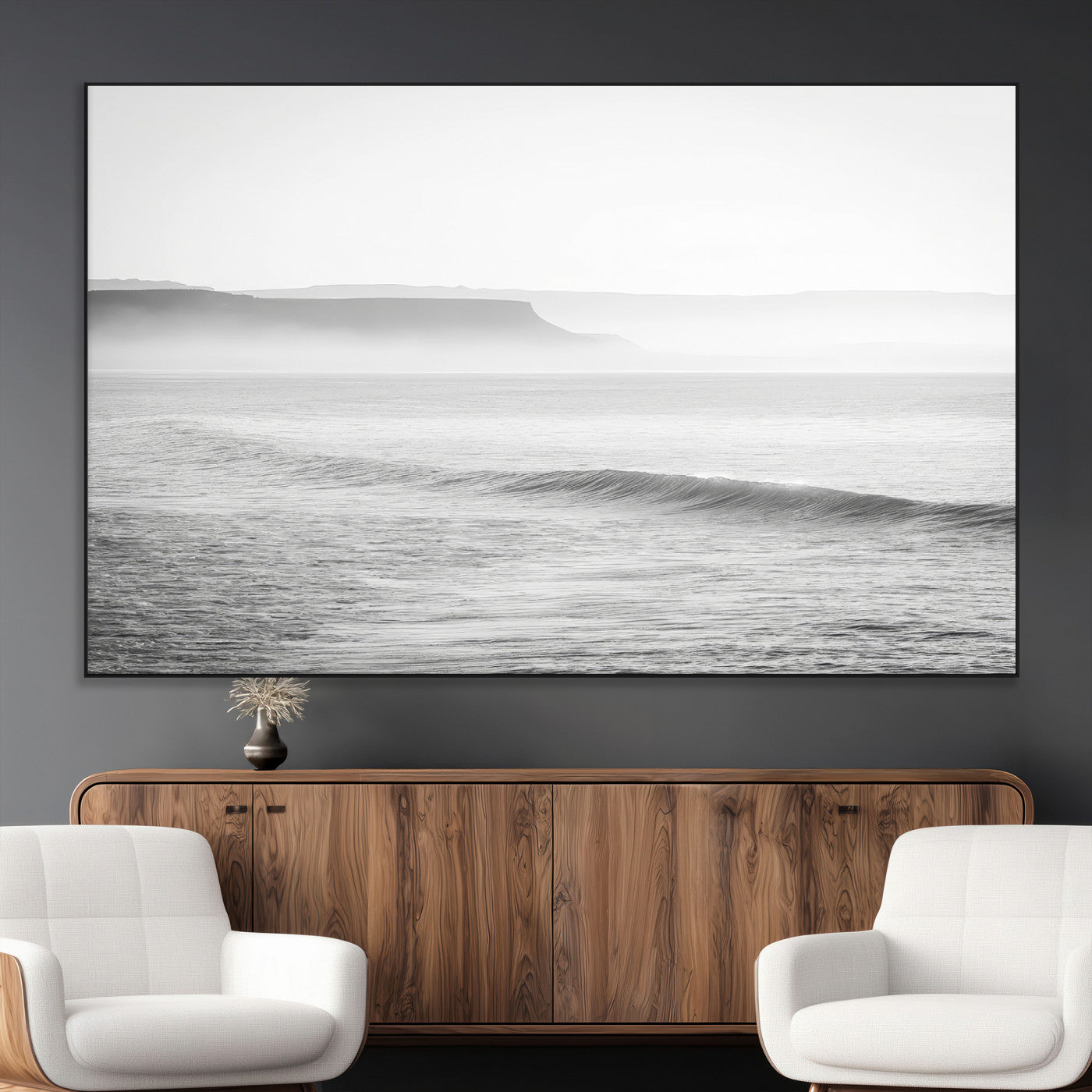 A black and white minimalist seascape featuring soft rolling waves and misty distant cliffs, creating a serene and timeless coastal atmosphere.