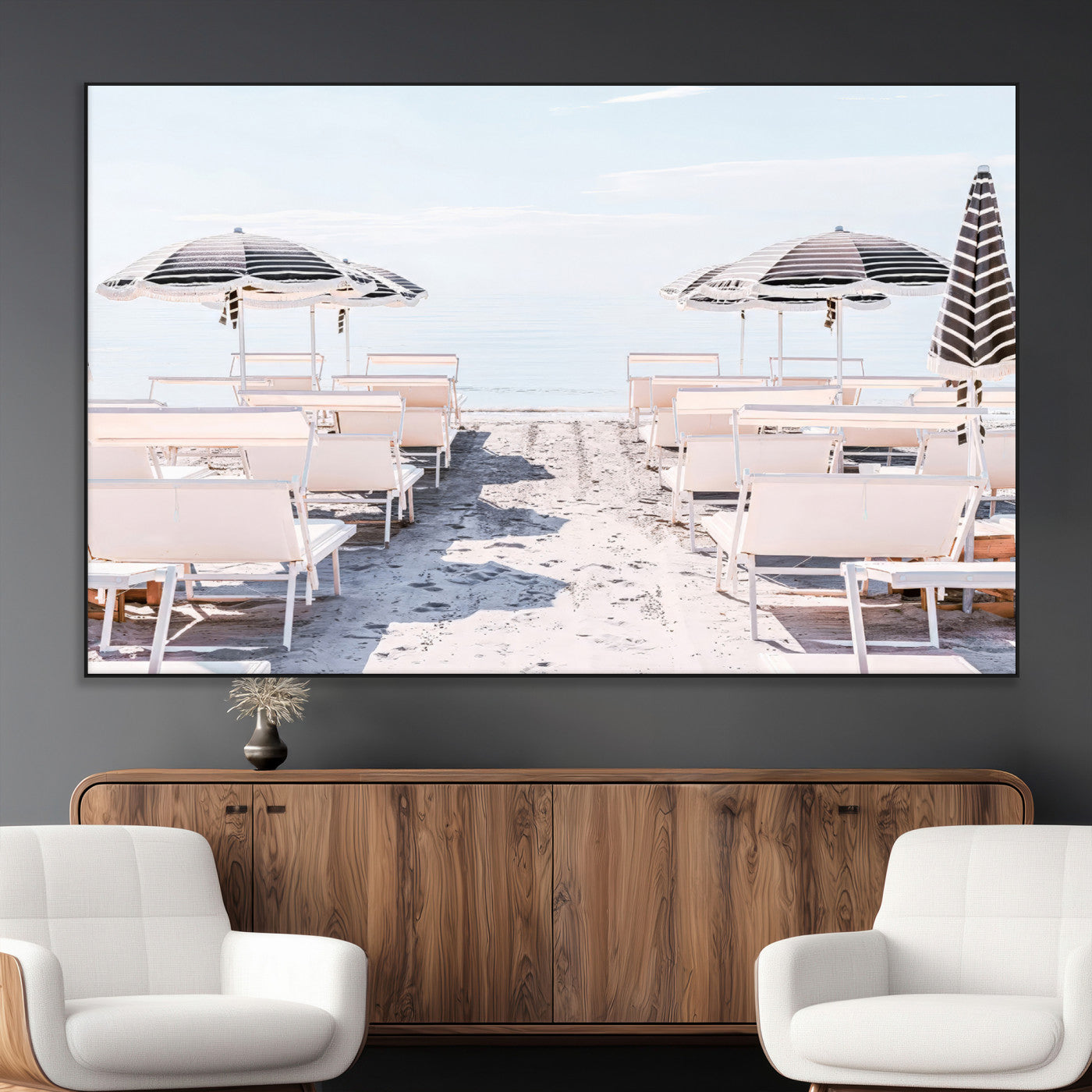 A serene minimalist beach scene featuring striped umbrellas, soft pastel sand, and an elegant lounge setup, creating a tranquil and stylish coastal retreat.