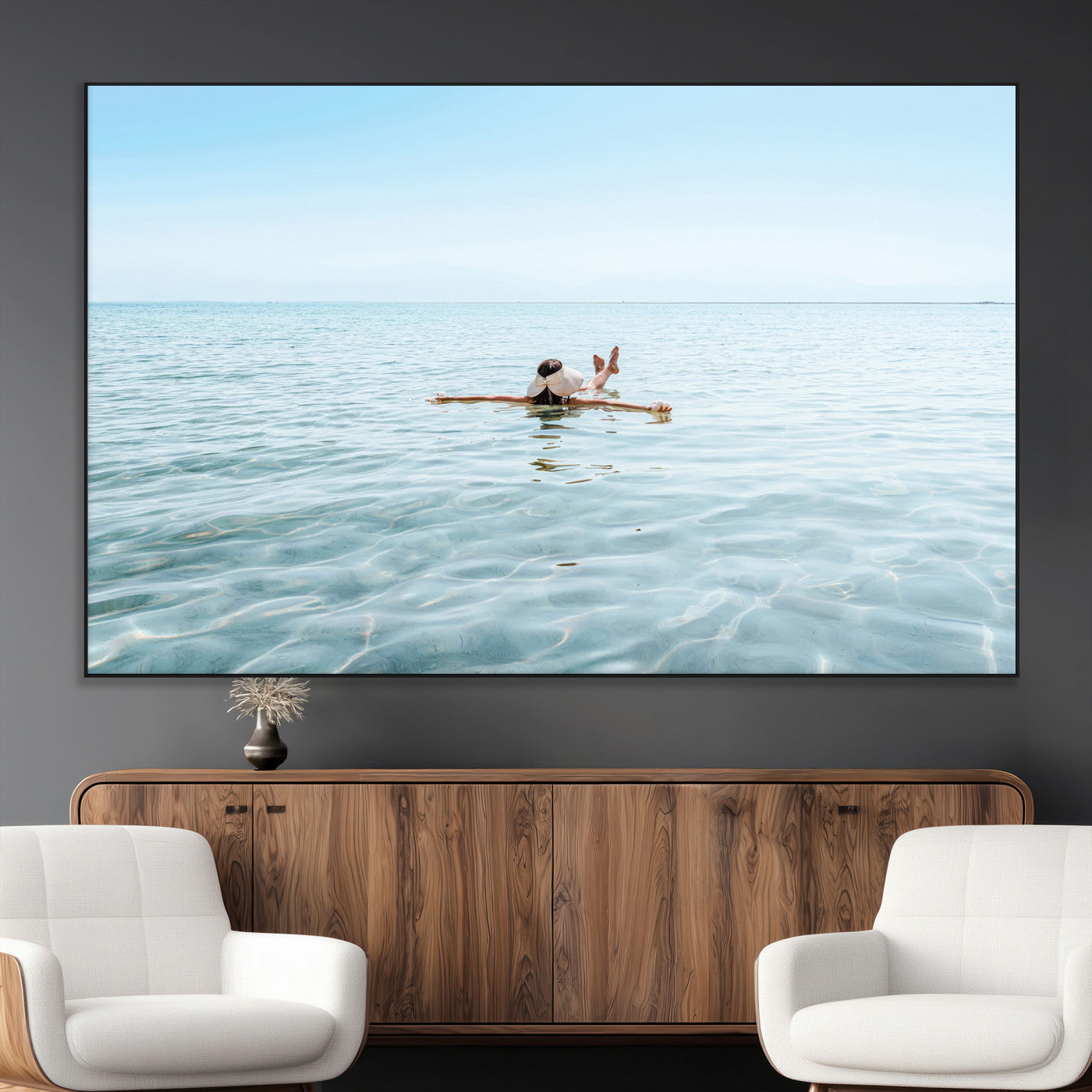 A peaceful minimalist scene of a person floating on crystal-clear water, surrounded by a vast open horizon, capturing relaxation and serenity in a tranquil aquatic setting.