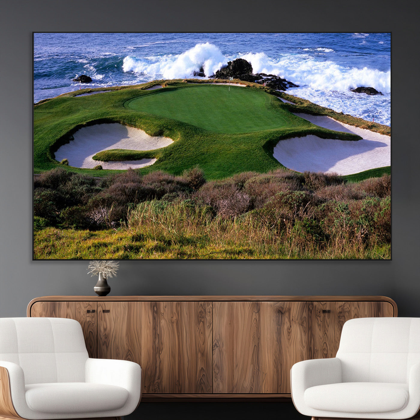 A scenic golf course located by the ocean, featuring a well-manicured green surrounded by sand traps and powerful ocean waves crashing on the shore.