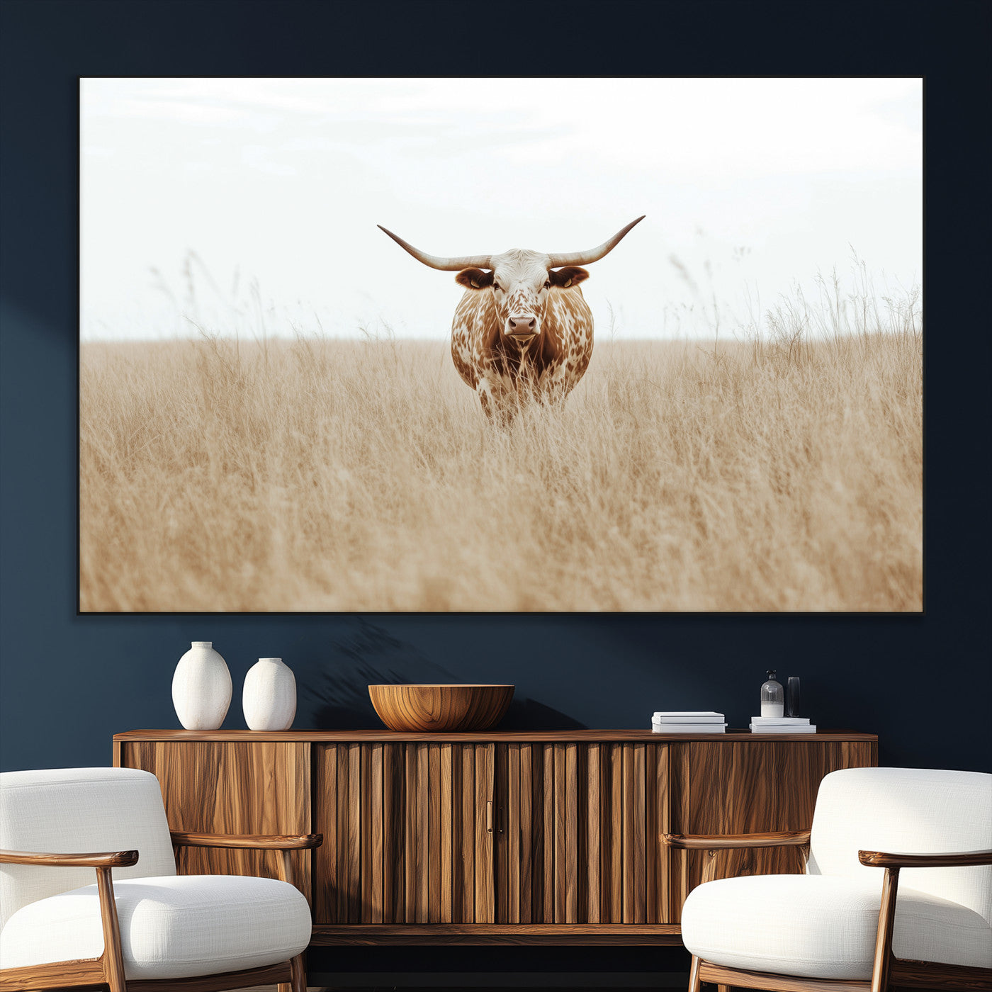Texas Longhorn bull standing alone in dry grass with neutral tones, ideal for rustic western or cowboy-themed wall decor.