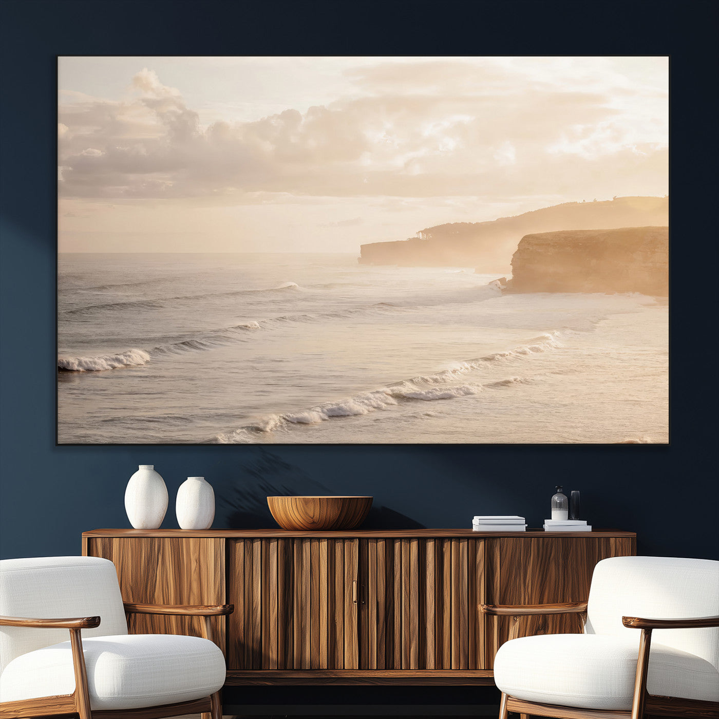 Golden hour seascape with misty cliffs and gentle waves rolling towards the shore, capturing a tranquil and warm coastal atmosphere.