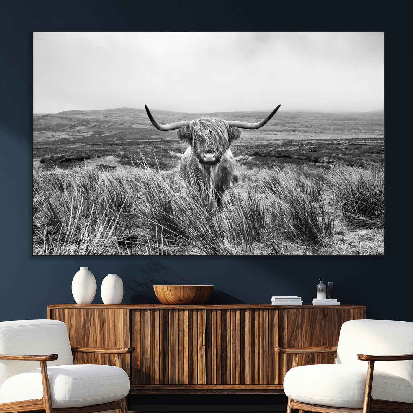 A black and white portrait of a Highland cow in a foggy Scottish countryside, capturing a rustic aesthetic and tranquil farm escape.