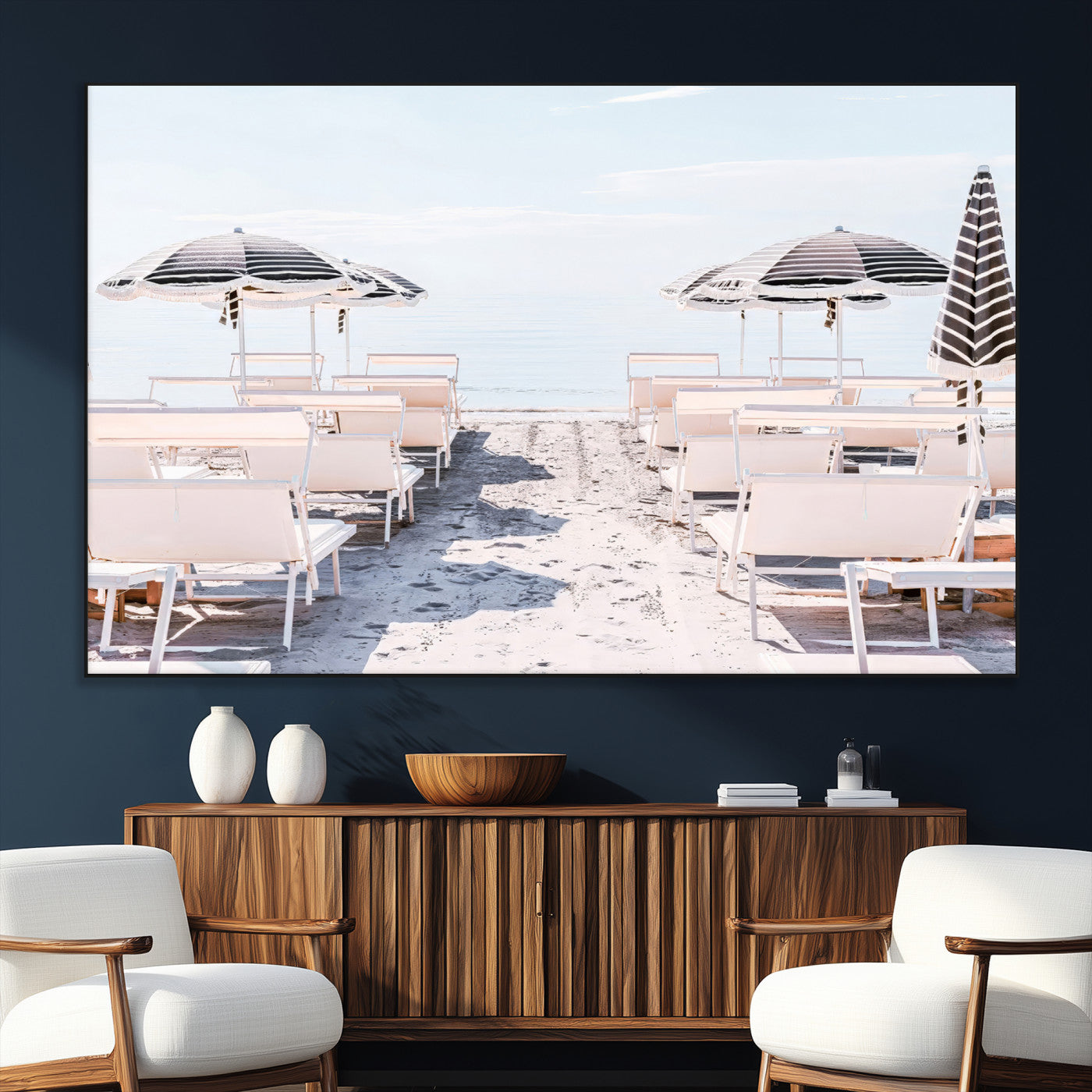 A serene minimalist beach scene featuring striped umbrellas, soft pastel sand, and an elegant lounge setup, creating a tranquil and stylish coastal retreat.
