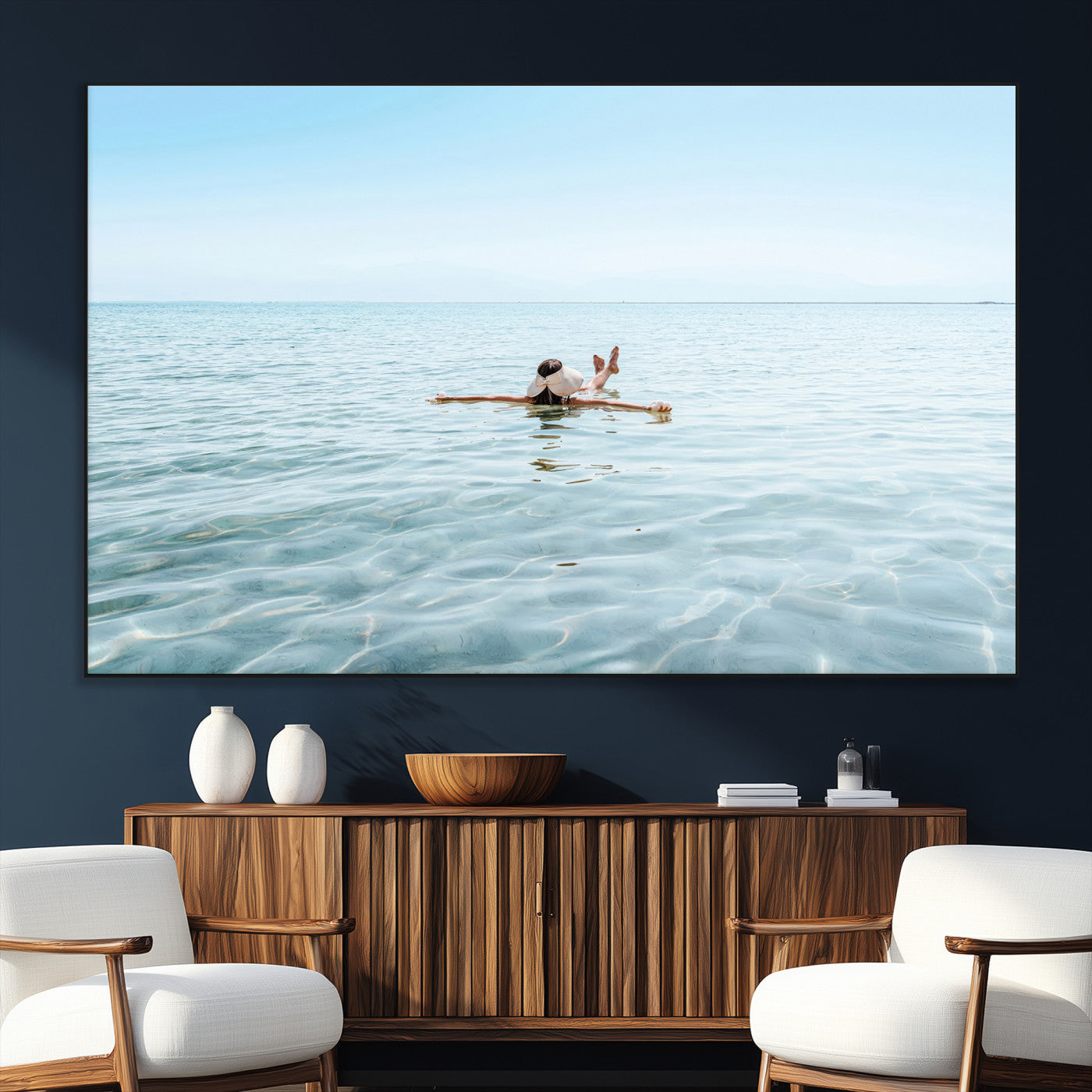 A peaceful minimalist scene of a person floating on crystal-clear water, surrounded by a vast open horizon, capturing relaxation and serenity in a tranquil aquatic setting.