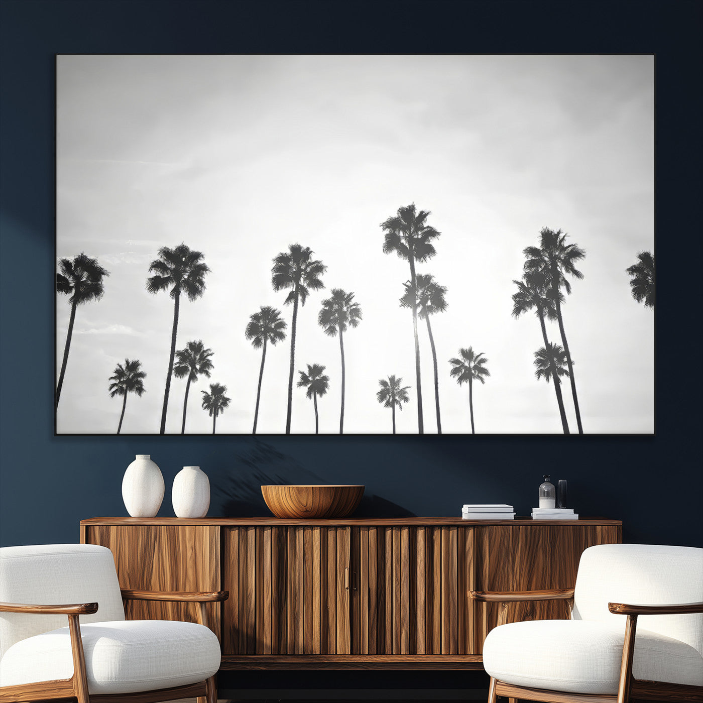 A black and white minimalist scene featuring tall palm trees silhouetted against a bright sky, creating a dreamy and timeless tropical aesthetic.