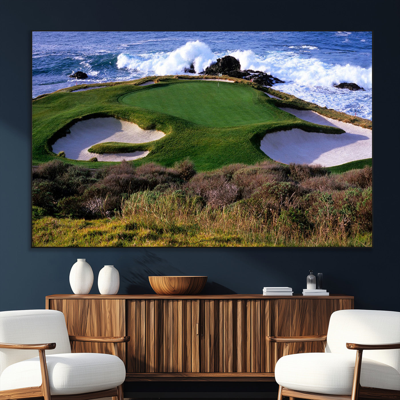 A scenic golf course located by the ocean, featuring a well-manicured green surrounded by sand traps and powerful ocean waves crashing on the shore.