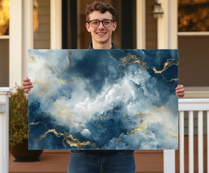 Modern living room featuring the Large Abstract Print - Luxe Blue and Gold Abstract Canvas Wall Art that showcases a bold cloudscape, perfect for modern home decor.