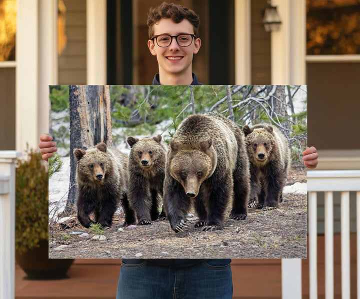 The Grizzly 399 and Cubs in Wild Flowers Wall Art Canvas Print, depicting grizzly bears amidst wildflowers, is elegantly displayed.