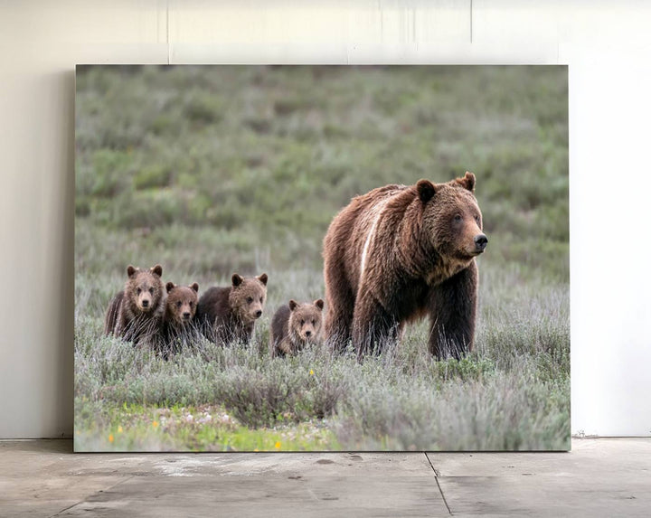 The large canvas print titled "Queen of the Tetons, 399 Grizzly Bear Cubs" showcases majestic wildlife photography of a bear and her cubs walking through the grass. This stunning canvas wall art, handmade in the USA, adds a charming touch to any room with its rustic decor appeal.