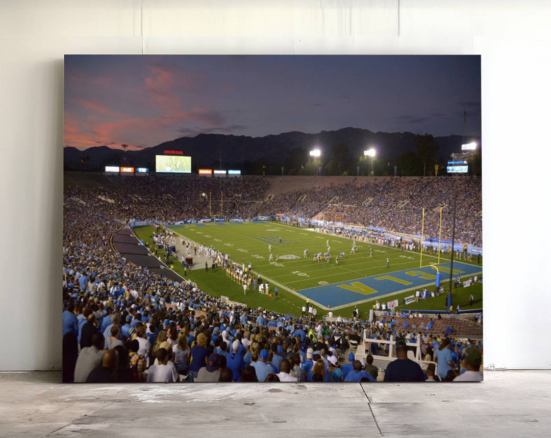 Admire the stunning wall art canvas depicting a UCLA Bruins game with a sunset over the Pasadena Rose Bowl Stadium.